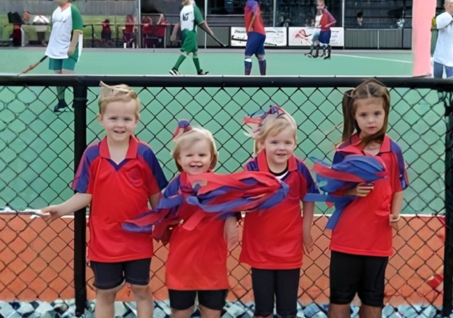 Four small hockey enthusiasts supporting the men’s first grade team before the 2000 grand final.